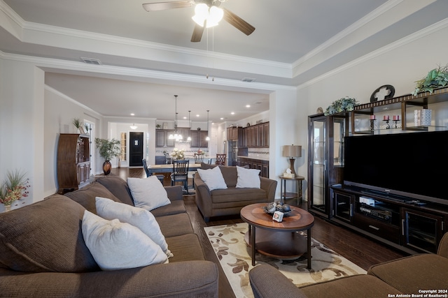 living room featuring ceiling fan, wood-type flooring, and ornamental molding