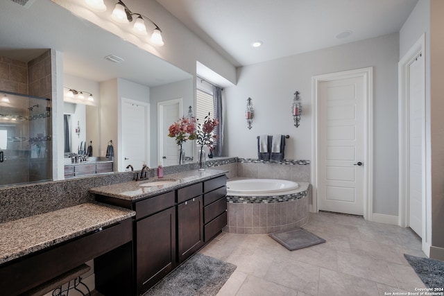 bathroom with tile patterned floors, vanity, and plus walk in shower