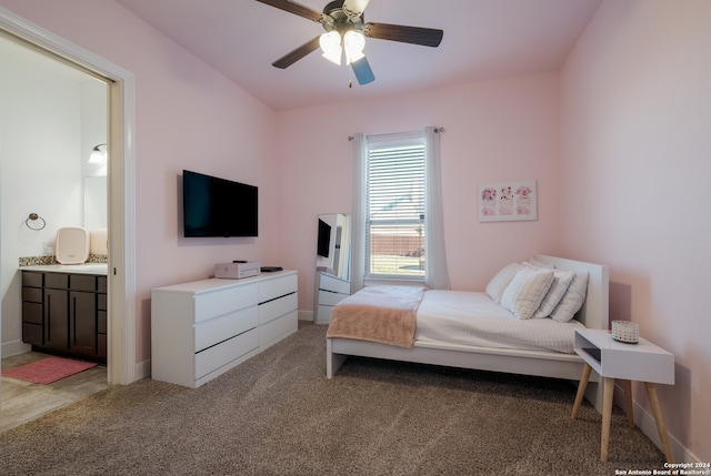 carpeted bedroom featuring ceiling fan and ensuite bathroom