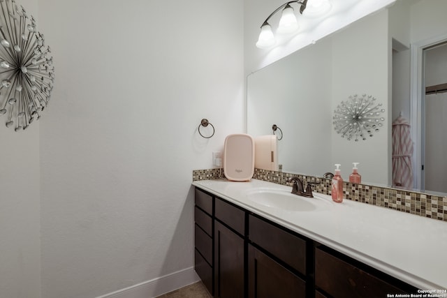 bathroom featuring vanity and backsplash