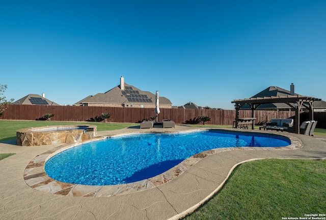 view of swimming pool featuring a lawn, a pergola, pool water feature, an in ground hot tub, and a patio area