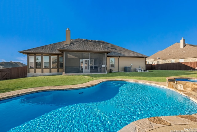 view of swimming pool featuring central AC, a sunroom, a yard, and an in ground hot tub