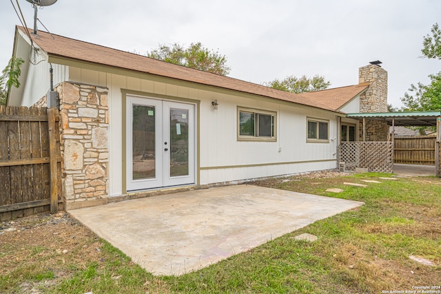 rear view of house featuring a lawn, a patio area, and french doors