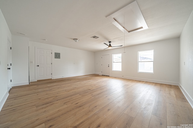 empty room featuring ceiling fan, light hardwood / wood-style floors, and electric panel