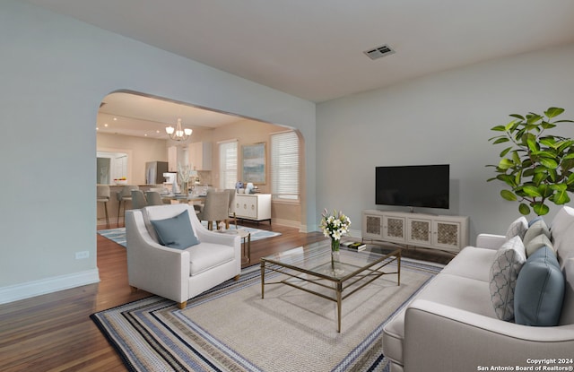 living room with a chandelier and wood-type flooring