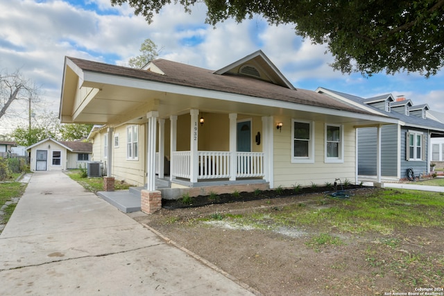 view of front of home with central AC unit and a porch