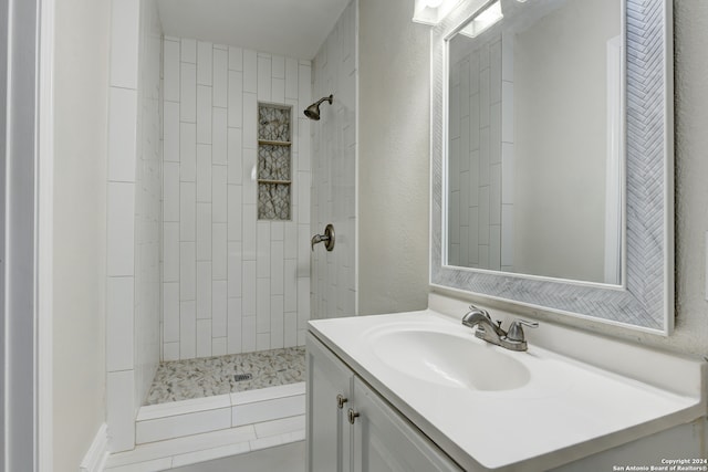 bathroom featuring vanity and a tile shower