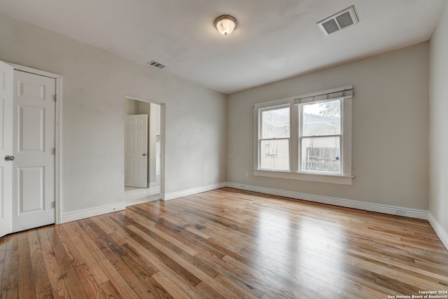 spare room with light hardwood / wood-style floors