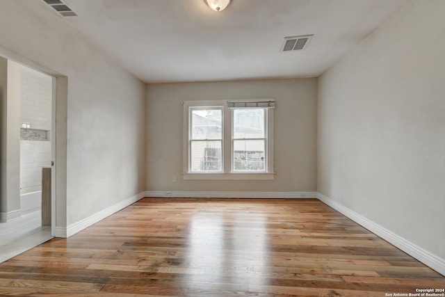 spare room with light hardwood / wood-style flooring