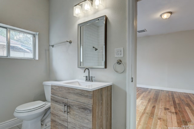 bathroom featuring vanity, toilet, and wood-type flooring