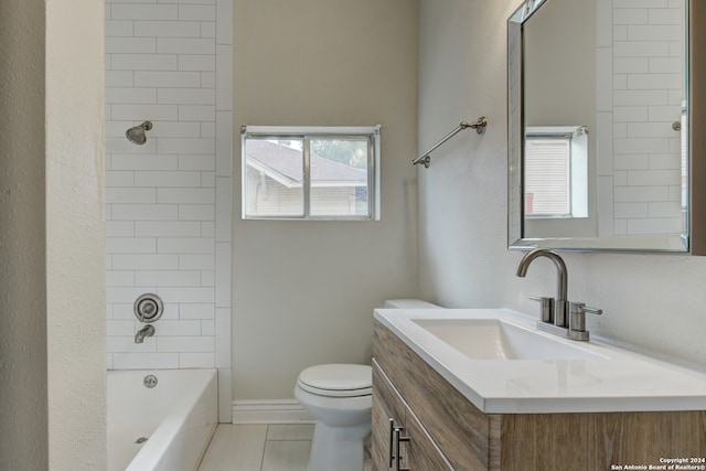 full bathroom with tile patterned floors, tiled shower / bath combo, toilet, and vanity