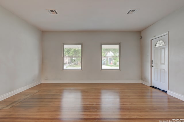 empty room with light hardwood / wood-style flooring