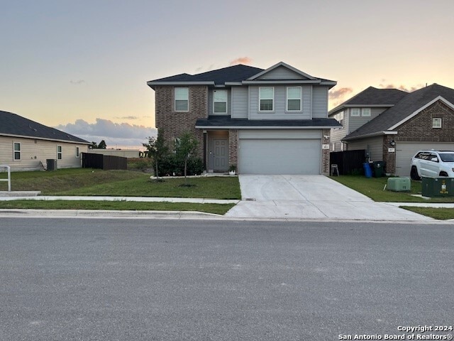 view of front property with a lawn and a garage