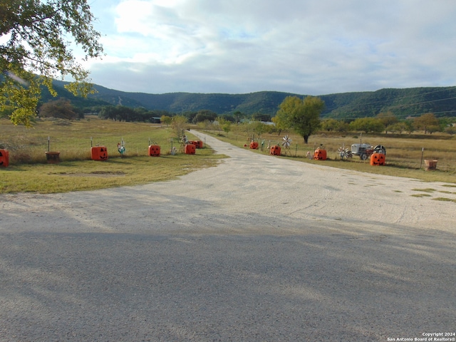 view of street with a mountain view and a rural view