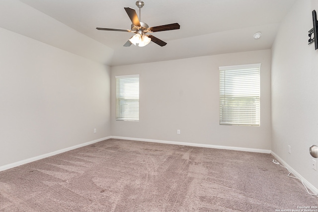 empty room with carpet flooring, ceiling fan, and lofted ceiling