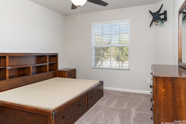 bedroom featuring ceiling fan and light colored carpet