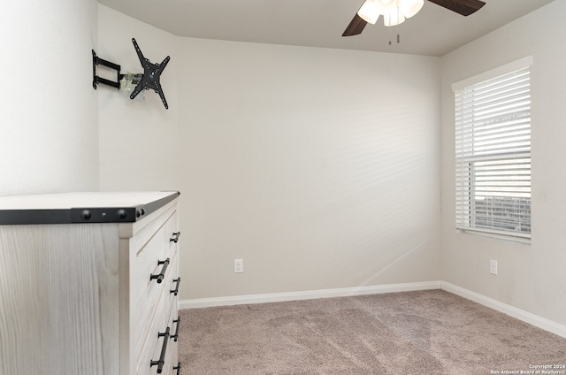 spare room featuring ceiling fan and light colored carpet