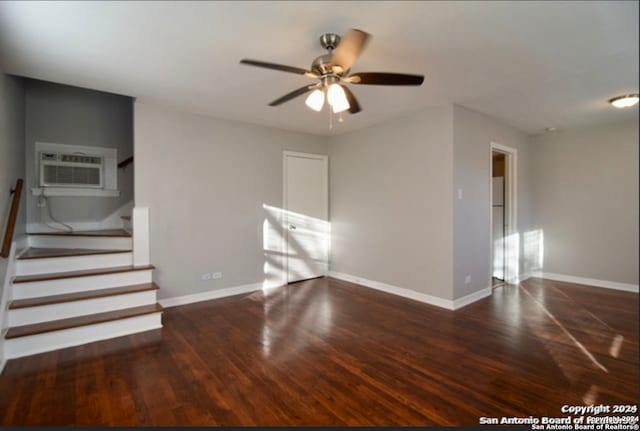 spare room featuring ceiling fan, dark wood-type flooring, and a wall mounted air conditioner