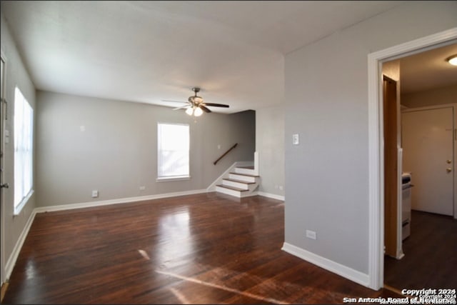 unfurnished living room with dark hardwood / wood-style flooring, a wealth of natural light, and ceiling fan