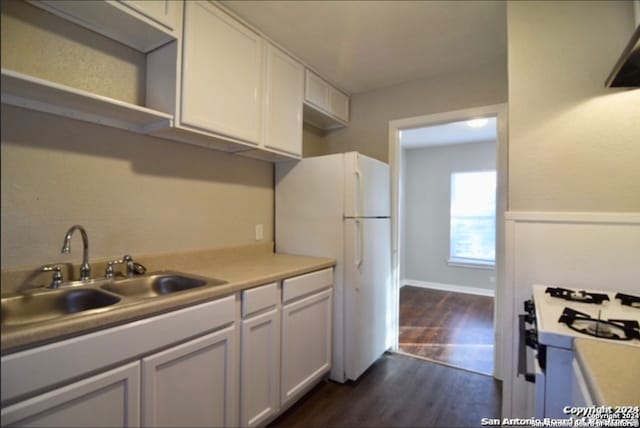 kitchen featuring sink, white cabinets, dark hardwood / wood-style floors, and white appliances