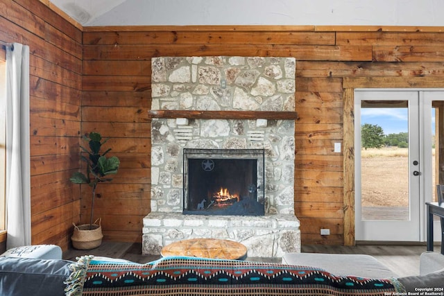 living room with hardwood / wood-style flooring, a fireplace, and vaulted ceiling