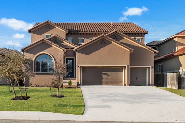 mediterranean / spanish home with a front yard and a garage