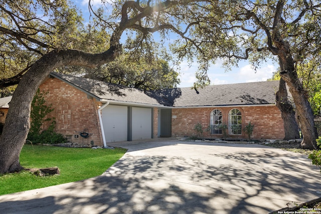 ranch-style house featuring a garage and a front yard