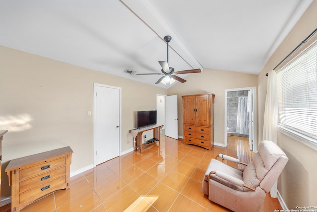 living area featuring vaulted ceiling with beams, ceiling fan, and light tile patterned floors