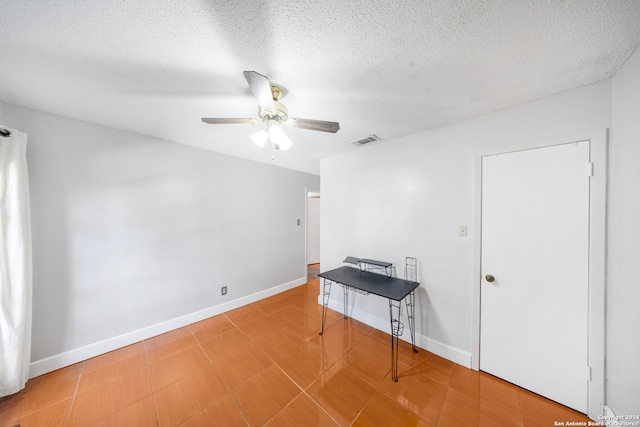 spare room featuring ceiling fan and a textured ceiling