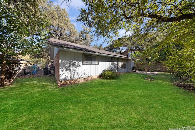 view of home's exterior with a yard and central AC unit