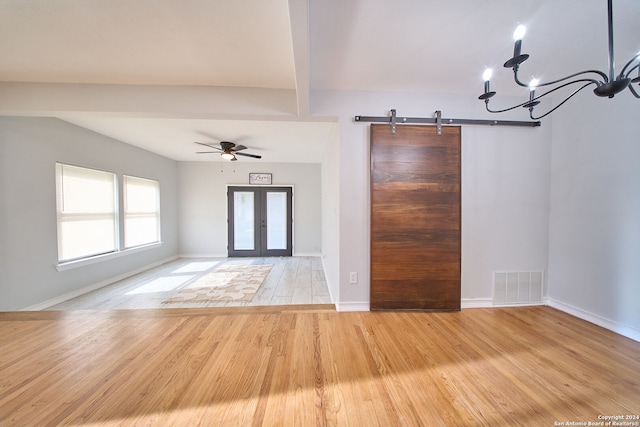 foyer with french doors, ceiling fan with notable chandelier, light hardwood / wood-style flooring, and beam ceiling