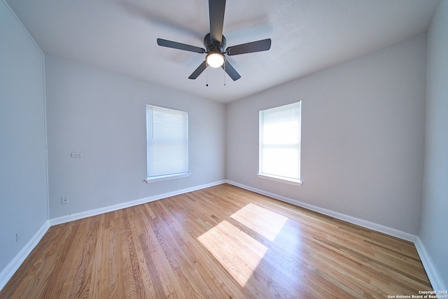 empty room featuring light wood-type flooring and ceiling fan