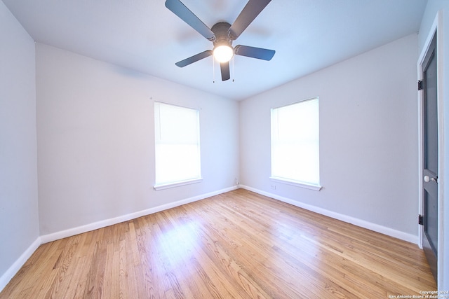 spare room with plenty of natural light, ceiling fan, and light hardwood / wood-style flooring