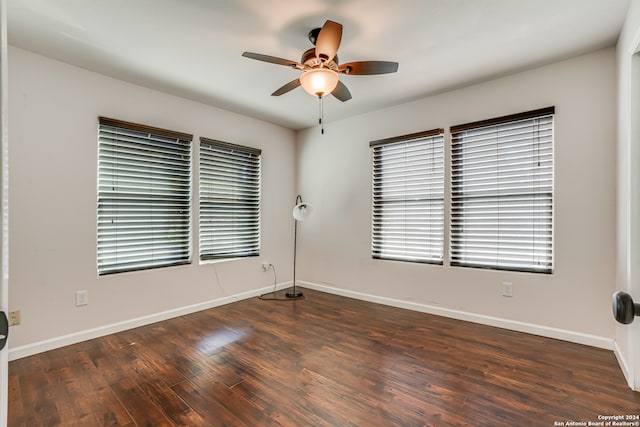 unfurnished room featuring ceiling fan and dark wood-type flooring