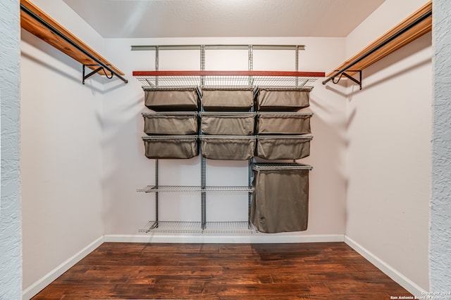 walk in closet featuring dark hardwood / wood-style floors