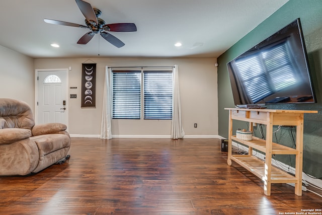 living room with dark hardwood / wood-style floors and ceiling fan