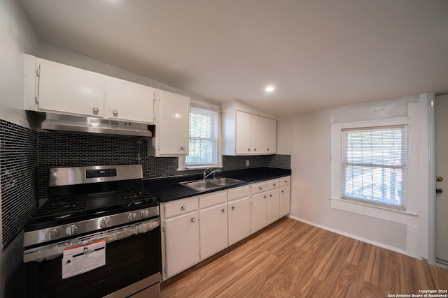 kitchen featuring gas range, sink, white cabinets, and light wood-type flooring