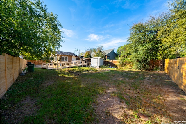 view of yard featuring a shed and a deck