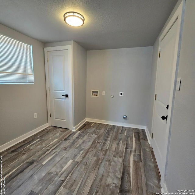 laundry room with hookup for an electric dryer, washer hookup, a textured ceiling, and dark hardwood / wood-style floors