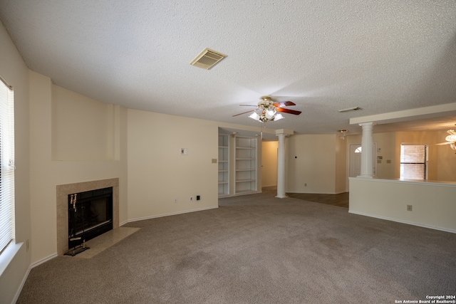 unfurnished living room with a wealth of natural light, carpet floors, a textured ceiling, and ceiling fan