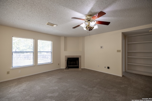 unfurnished living room featuring ceiling fan, a textured ceiling, and dark colored carpet