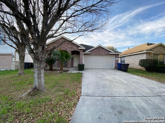 view of front of house with a garage and a front lawn