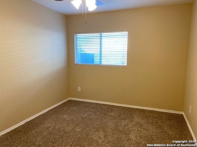 unfurnished room featuring carpet flooring and ceiling fan