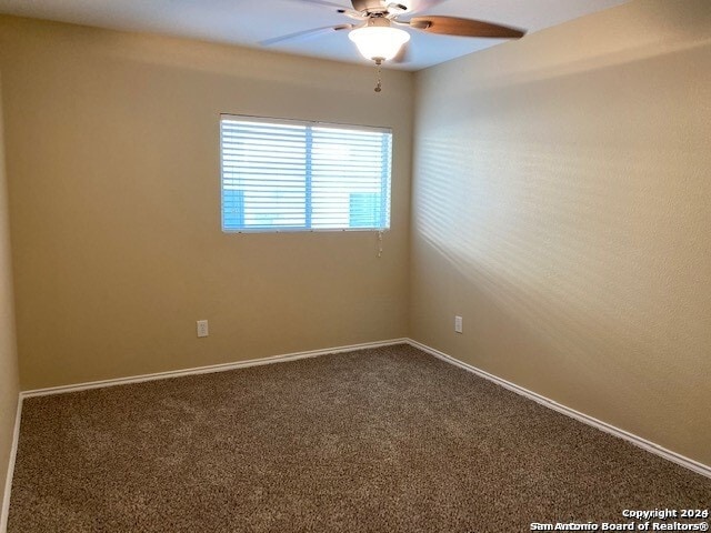 spare room featuring carpet flooring and ceiling fan