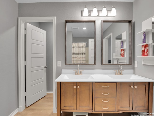 bathroom featuring hardwood / wood-style flooring and vanity