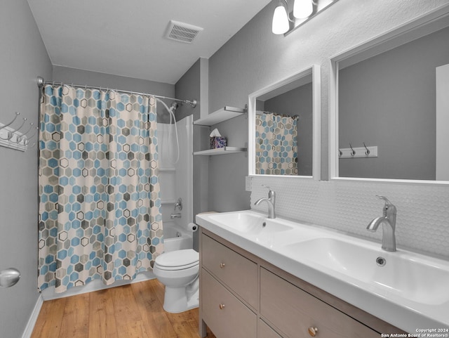 full bathroom with shower / bathtub combination with curtain, wood-type flooring, toilet, decorative backsplash, and vanity