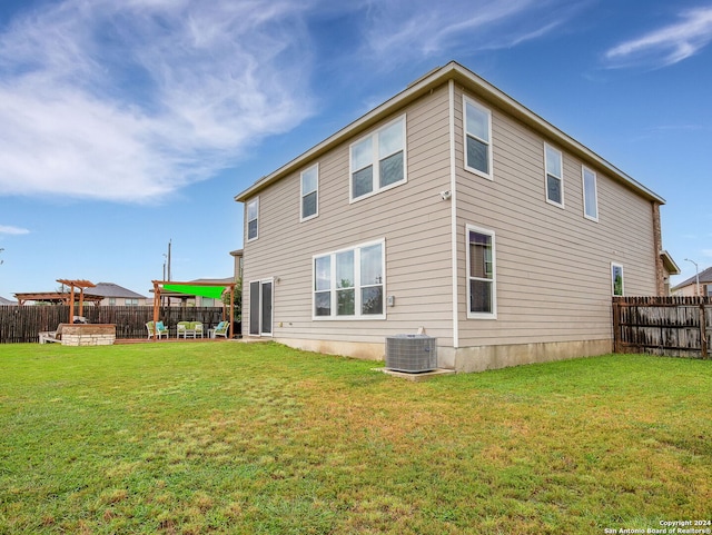 back of property featuring a lawn, central air condition unit, and a patio