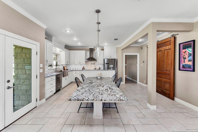 dining space with ornamental molding and sink