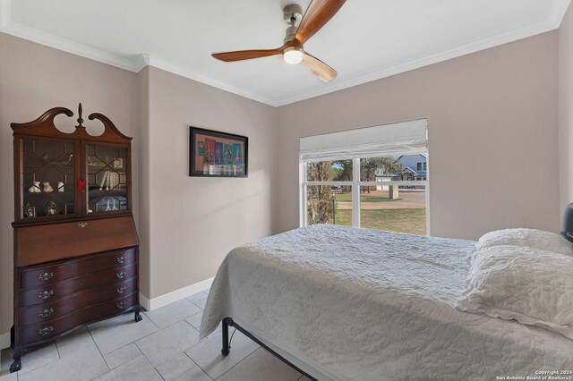 bedroom featuring ceiling fan, crown molding, and light tile patterned floors