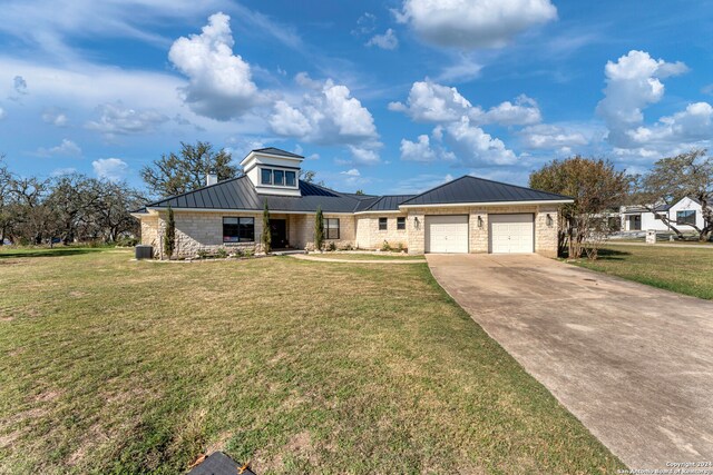 view of front of property with a garage and a front lawn